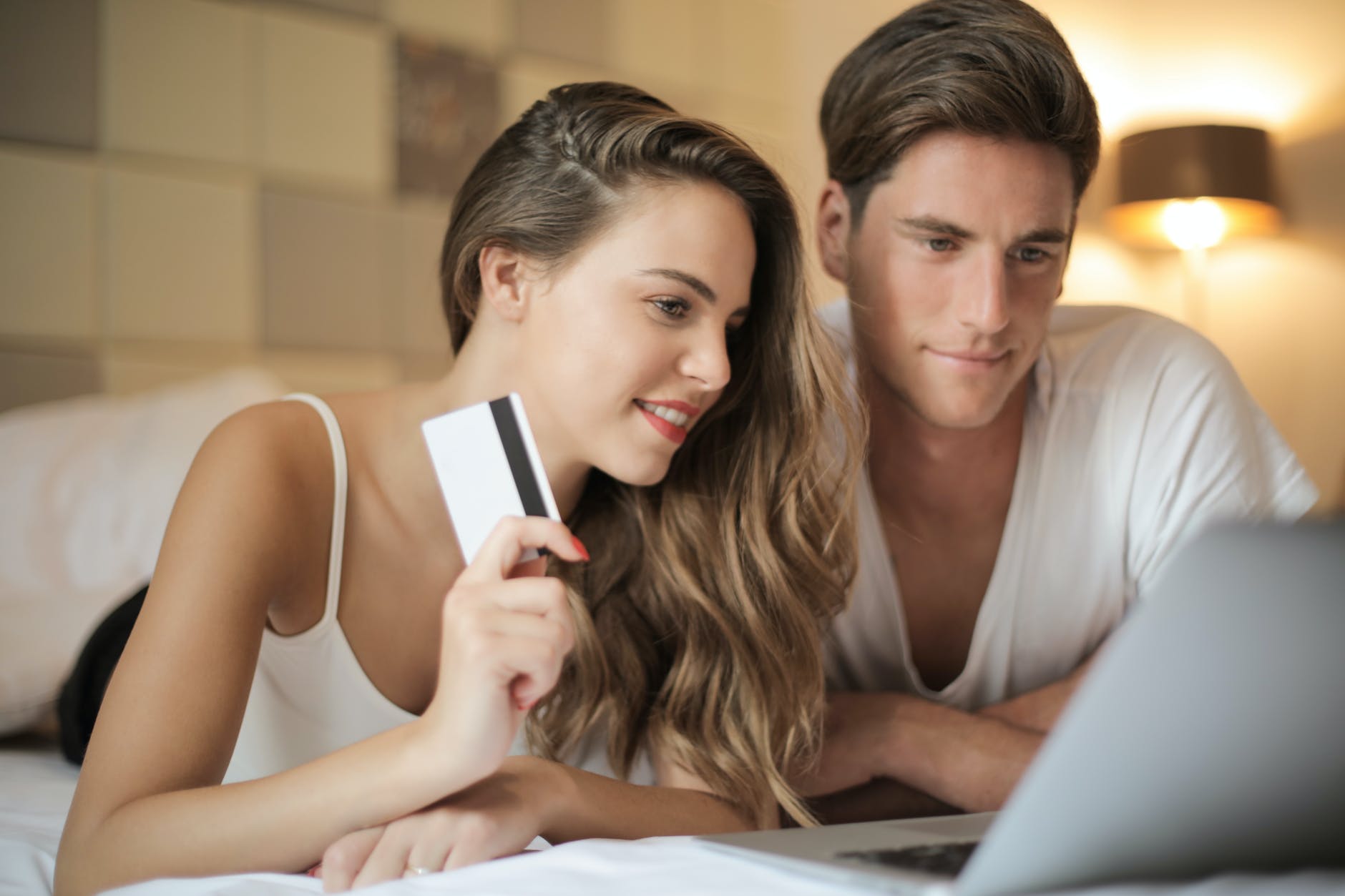 cheerful couple making online purchases at home