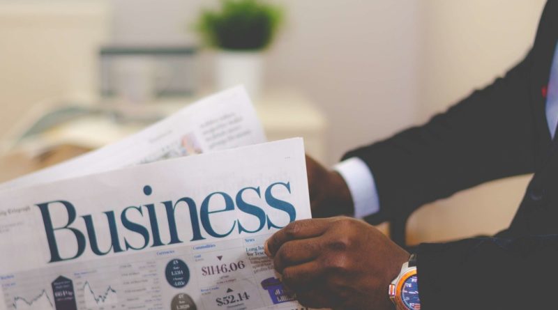 person holding white and blue business paper