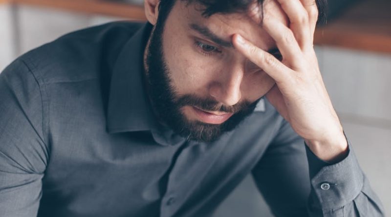 man in blue dress shirt wearing black framed eyeglasses