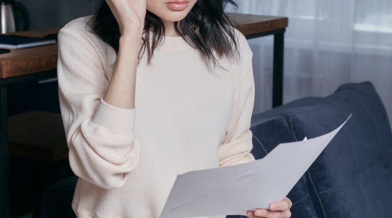 woman feeling disappointed while looking at some papers