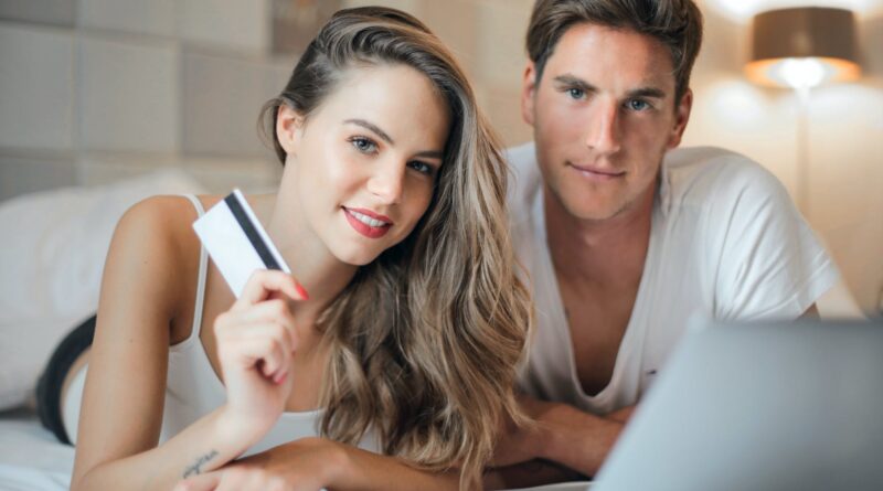 happy young couple doing purchase on internet together at home